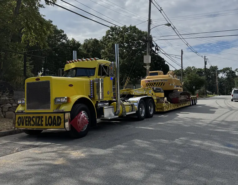 Aaron Excavating tractor trailer hauling equipment to a site work project